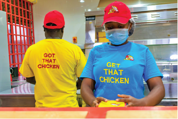 ChickenRun chicken being hand-breaded in-store
